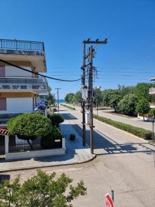 an empty street with a stop sign next to a building at Entire Bedroom Apartment with big Balcony Perfect for Families Mishev in Nea Moudania