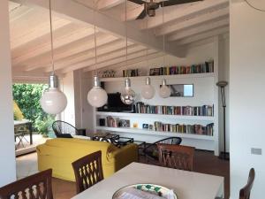 a living room with a yellow couch and a book shelf at Casa di Jo in Imperia