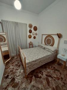 a bedroom with a bed and a table and a window at Stellammare Apulian House B&B in Bari