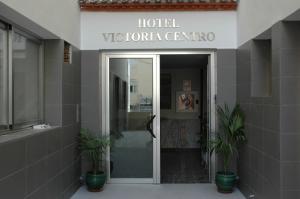 a hotel victoria centre with potted plants in front of a door at Hotel Victoria Centro in Almuñécar