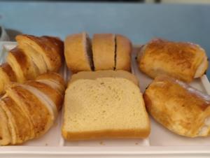 a plate of bread and pastries on a table at Hôtel La Côte d'Or in Philippeville