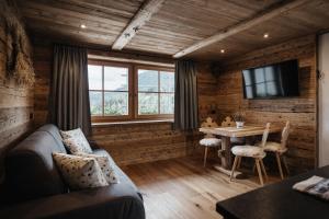 a living room with a couch and a table at Chalet Rich in Val Badia in San Martino in Badia