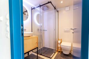a bathroom with a shower and a toilet and a sink at Toni Retzo Rooms in Himare +205 photos