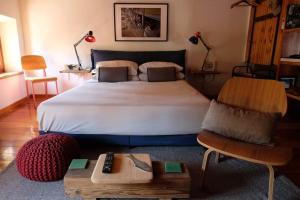 a bedroom with a large bed and a table at La casa dei ciclisti in Ponti Sul Mincio