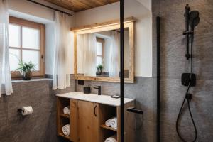 a bathroom with a sink and a shower at Chalet Rich in Val Badia in San Martino in Badia +39 photos