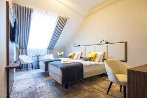 a hotel room with two beds and a desk at DReAM Boutique Residence in Krakow