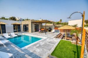 a villa with a swimming pool and a patio at Terra Secreta Luxury Villas in Lartos
