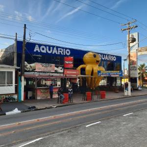 a large yellow teddy bear sign in front of a store at Apartamento Guaruja Enseada 2 Quadra da Praia Atrás do Aquario in Guarujá