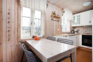 a kitchen with a table and chairs in a room at Hotel Dimon in Stora Mork
