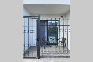 an iron gate with two chairs and a table at Arkadiya Sky Jakuzi & Angelika 23 in Odesa