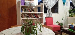 a room with a table and a book shelf with books at El Rincon de los Poetas in Nueva Imperial