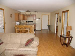 a living room with a couch and a kitchen at Adventure High Cabin in Seal Cove