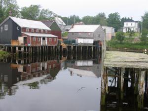 a body of water with buildings and houses at Adventure High Cabin in Seal Cove