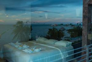 a bedroom with a bed with a view of the ocean at Hotel Noor in Chetumal