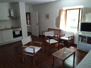 a living room with chairs and a table and a kitchen at Jankovich Castle in Benkovac