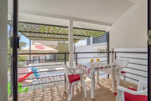 a balcony with a table and chairs and a pool at Villa Krofnica in Ulcinj +6 photos