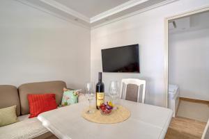 a living room with a white table with wine glasses at Villa Krofnica in Ulcinj