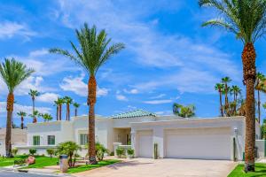 a house with palm trees in front of it at Luxury Estate in Indian Wells Country Club in Indian Wells