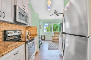 a kitchen with a stainless steel refrigerator at Happiness Comes in Waves in Cape Canaveral