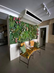 a living room filled with furniture and plants at Aton Plaza Hotel in Goiânia