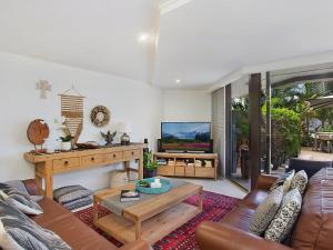 uma sala de estar com um sofá e uma televisão em The Rocks Resort Apartment GE em Gold Coast