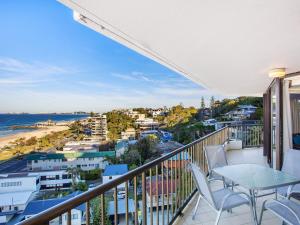 a balcony with a table and chairs and a view of the ocean at The Rocks Resort Unit 9J in Gold Coast