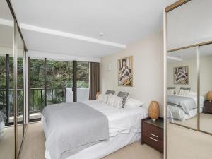 a bedroom with a large bed and a large window at The Rocks Resort Unit 3D in Gold Coast