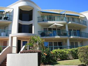 a large white building with blue balconies at Riverview Unit 6 in Gold Coast