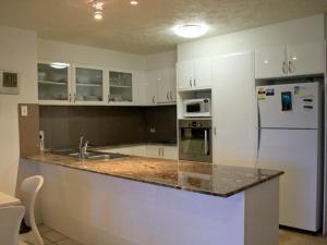 a kitchen with white cabinets and a counter top at Riverview Unit 6 in Gold Coast