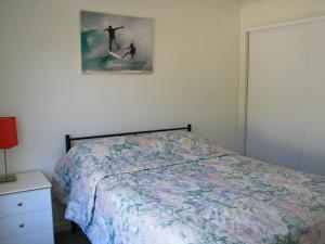 a bedroom with a bed and a painting on the wall at Riverview Unit 6 in Gold Coast