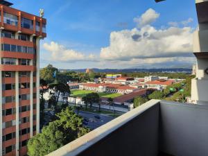 a view of a city from the balcony of a building at Apartamento 908 Cortijo Reforma zona 9 in Guatemala