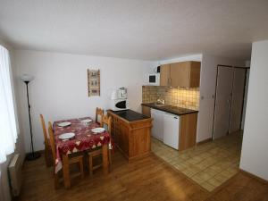 a kitchen with a table and a kitchen with a dining room at Studio Valloire, 1 pièce, 4 personnes - FR-1-263-486 in Valloire