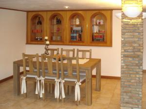 a dining room with a wooden table and chairs at Kochili Apartments in Neos Pirgos +35 photos