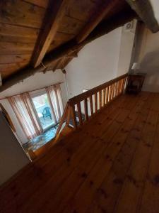 an attic room with a wooden staircase and a window at Beautiful house located on a hill in Samos Island, 400 m from an organized beach in Koumeika