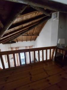 an attic room with wooden floors and windows at Beautiful house located on a hill in Samos Island, 400 m from an organized beach in Koumeika
