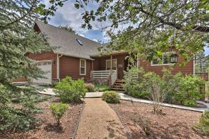 a brown house with a garden in front of it at Near Bear Mountain and Big Bear Lake Gem with Hot Tub in Big Bear Lake