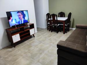 a living room with a flat screen tv and a table at OBELISCO SARMIENTO CENTER in Buenos Aires