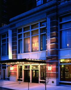 a large building with lights in the windows at night at Soho Grand Hotel in New York
