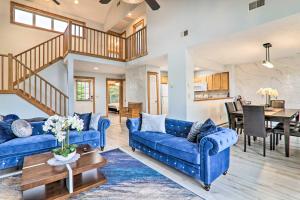 a living room with blue couches and a table at Modern Camelback Mountain Home half Mi to Skiing! in Tannersville