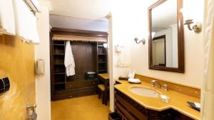 a bathroom with a sink and a mirror at Fort JadhavGADH -A GADH Heritage Hotel in Pune