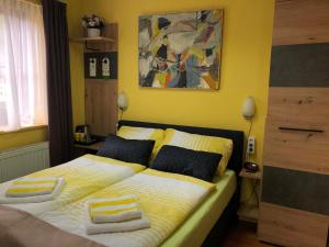 a bedroom with two beds and a painting on the wall at Astoria Hotel Heimbach in Heimbach