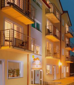 a building with balconies on the side of it at Noclegi-Bajka in Ustronie Morskie