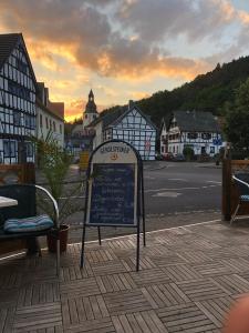 ein Schild an der Tafel auf einem Bürgersteig in einer Stadt in der Unterkunft Astoria Hotel Heimbach in Heimbach