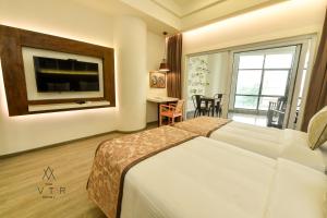 Cama ou camas em um quarto em The Avatar Hotel & Convention