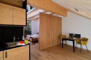 a kitchen with a sink and a table in a room at Apartmenthaus Nr 1 in Lienz