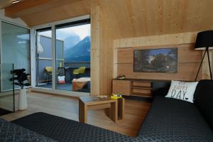 a living room with a couch and a large window at Apartmenthaus Nr 1 in Lienz