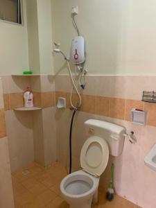 La salle de bains est pourvue de toilettes et d'une douche. dans l'établissement Awani Homestay, à Permatang Janggus