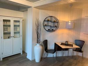 a dining room with a table and a vase at Notodden Sentrum Apartment NO 1 in Notodden