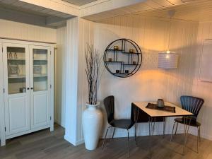 a dining room with a table and a vase at Notodden Sentrum Apartment NO 1 in Notodden +15 photos