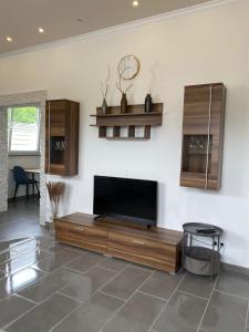 a living room with a flat screen tv on a wall at Ferienwohnung 1 Schweizer in Geisingen